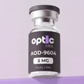 A clear vial with a black label reading Optic Labs AOD-9604 5mg sits against a light purple background. Optic Labs Au